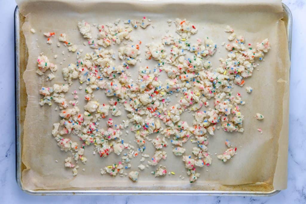 milk bar cake crumbs on a baking sheet