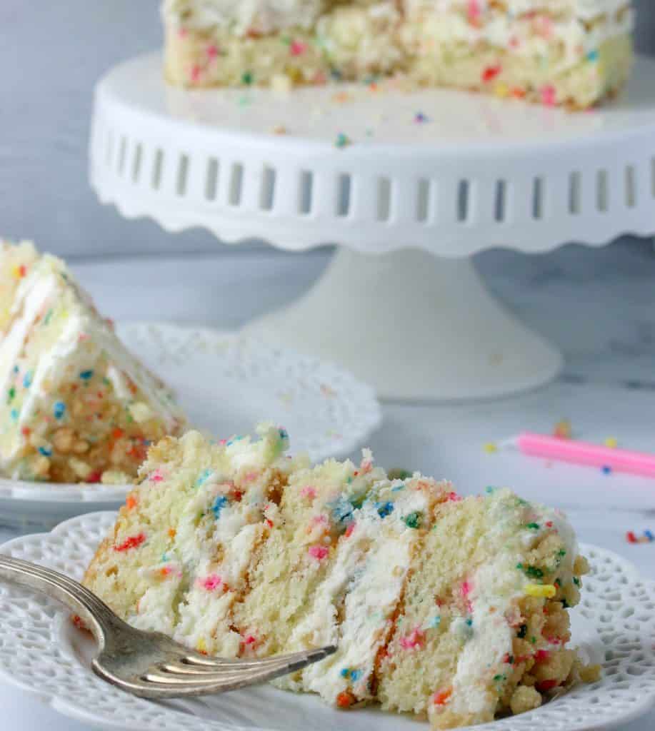 milk bar birthday cake slice on a plate with a fork