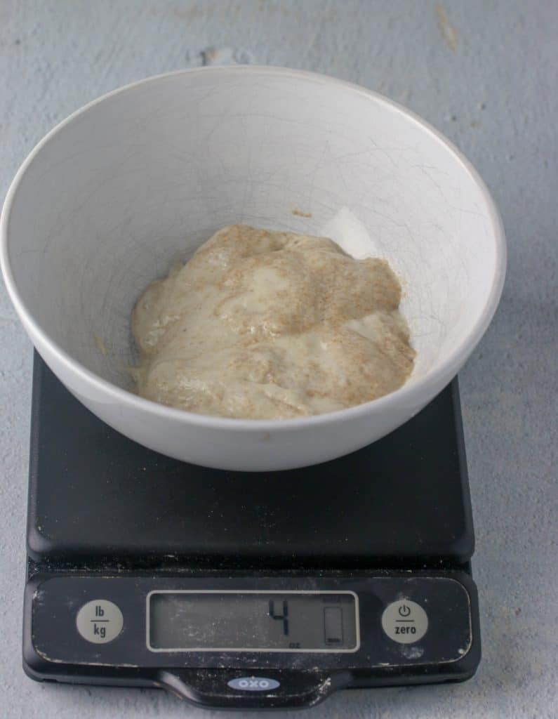 4 ounces of starter in a bowl on a digital scale