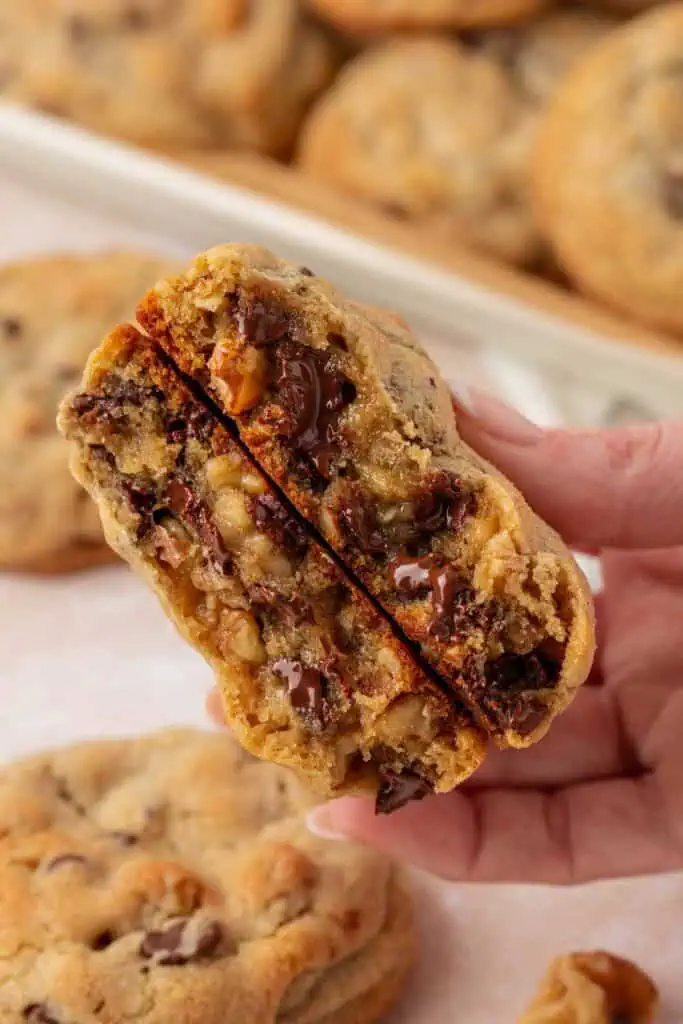 hand holding a cookie broke in half
