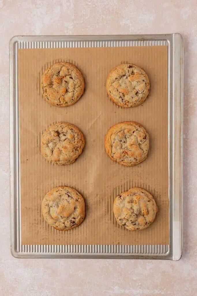 six baked cookies on a cookie sheet