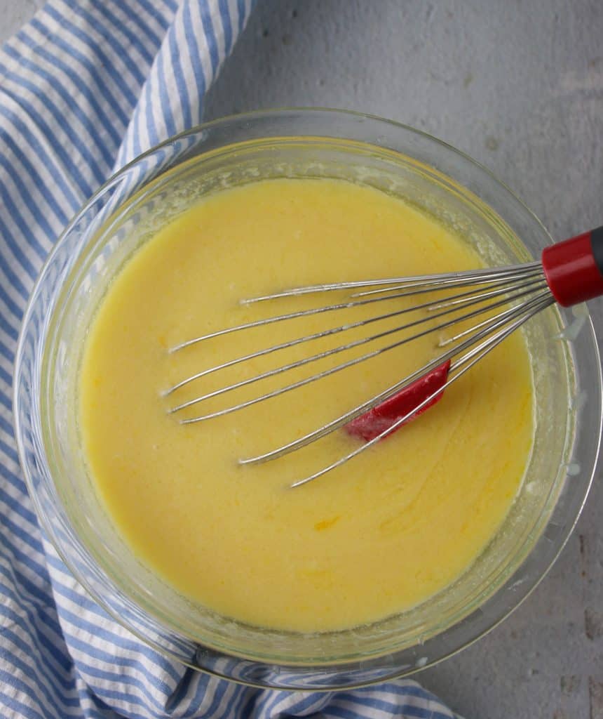 cornbread wet ingredients in a bowl with a whisk