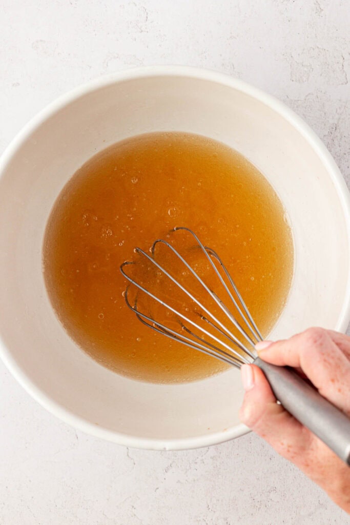 wacky cake wet ingredients in a bowl with a whisk