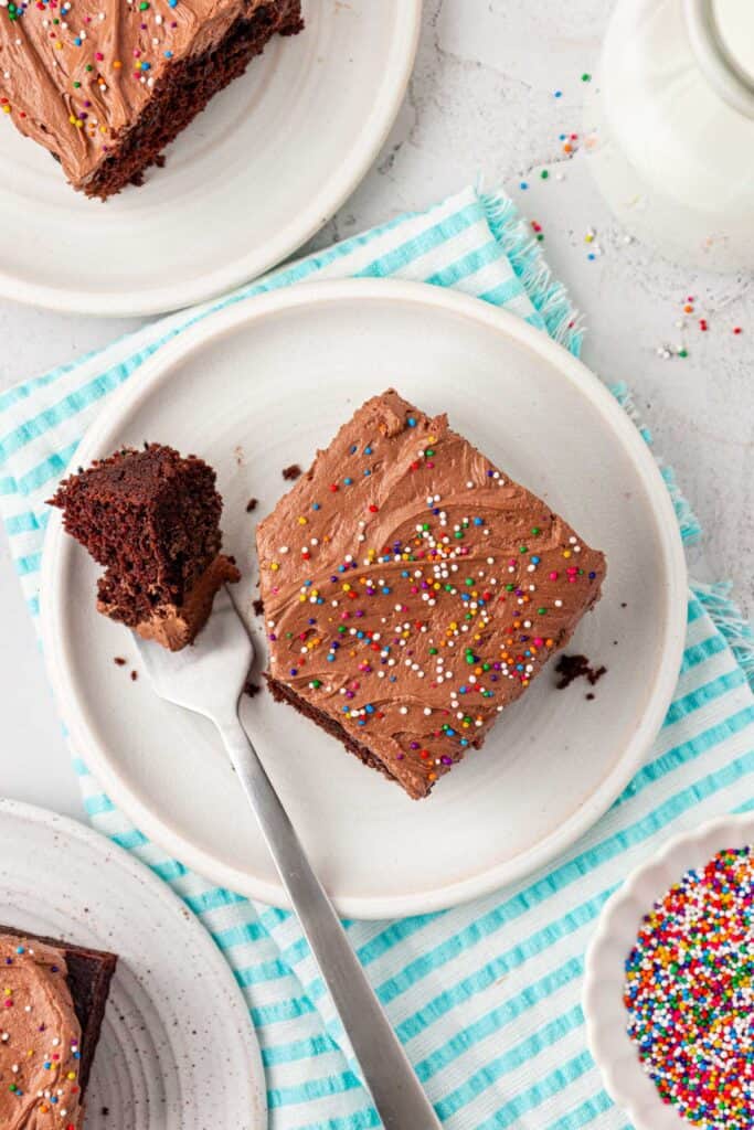 top down view of a slice of chocolate crazy cake with a forkful on a plate