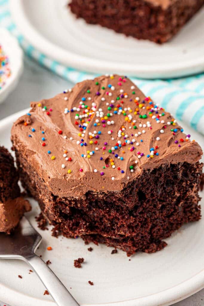 slice of chocolate crazy cake, or depression cake, on a plate with a bite missing