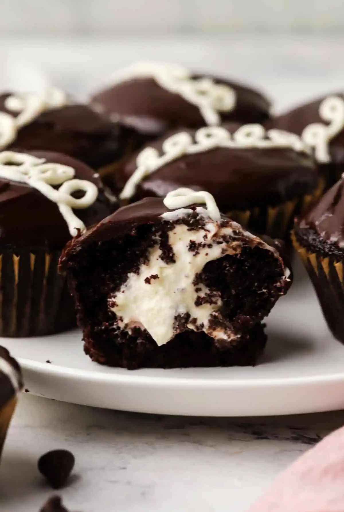 a cupcake cut in half on a plate with more cupcakes