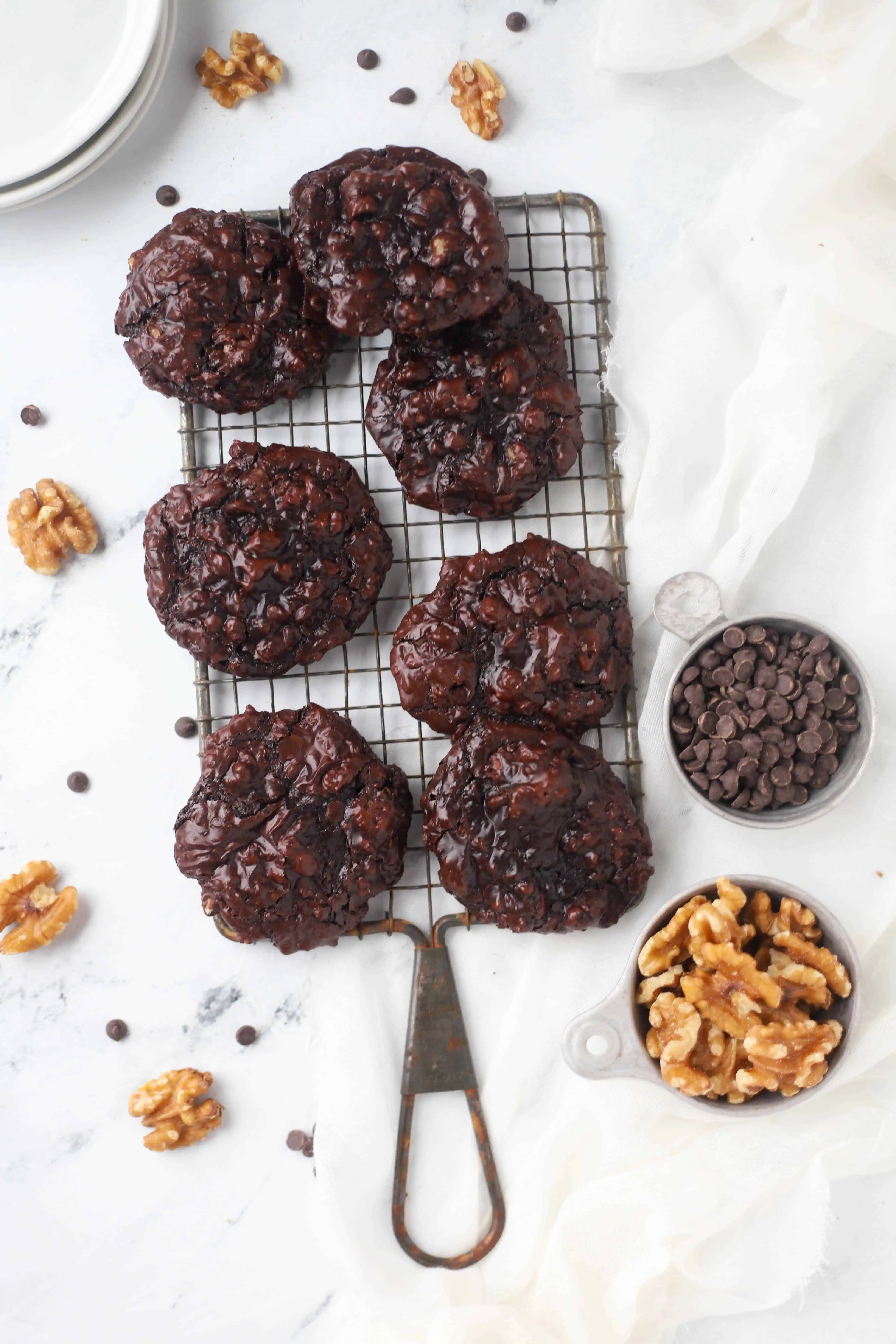 flourless chocolate walnut cookies on a cooling rack