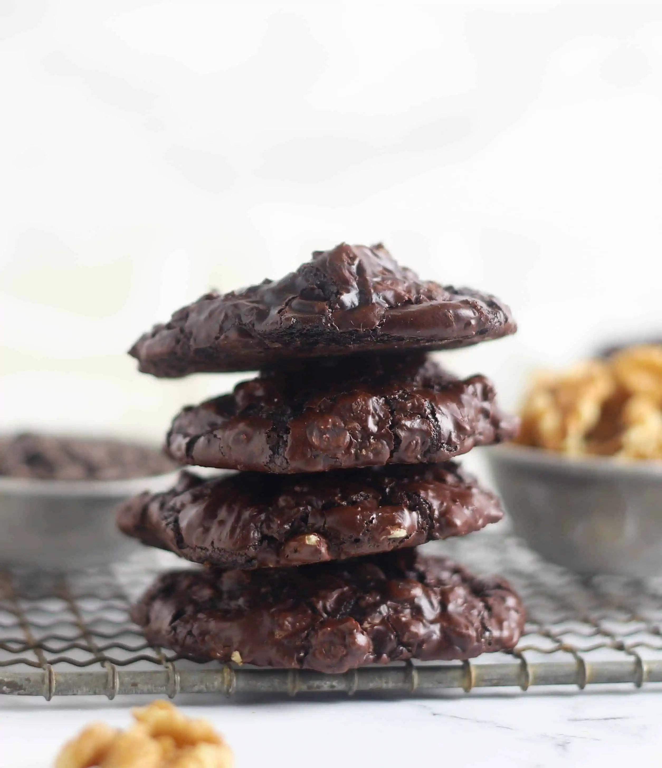 four flourless chocolate walnut cookies stacked
