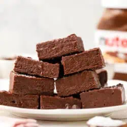 a plate of nutella fudge squares stacked on top of each other