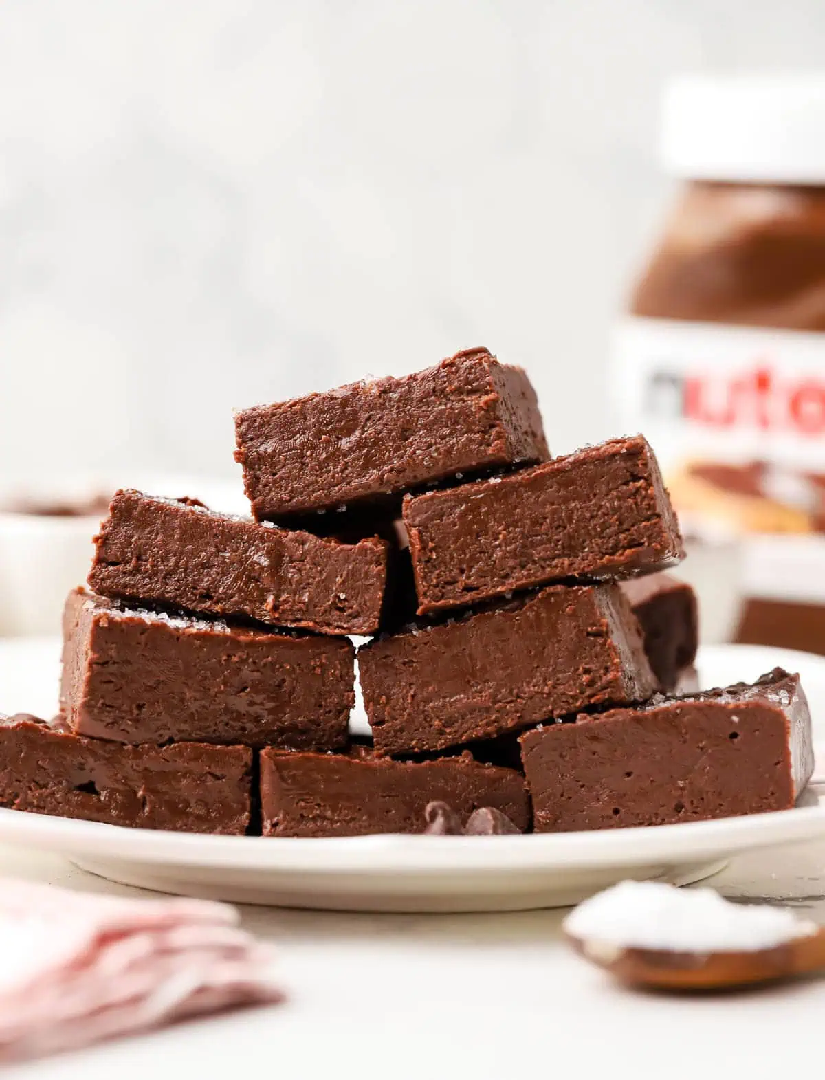 a plate of nutella fudge squares stacked on top of each other