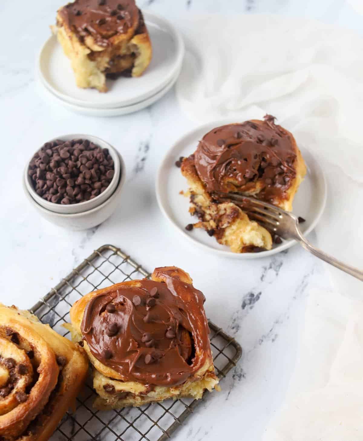 chocolate cinnamon rolls with one that has a fork in it