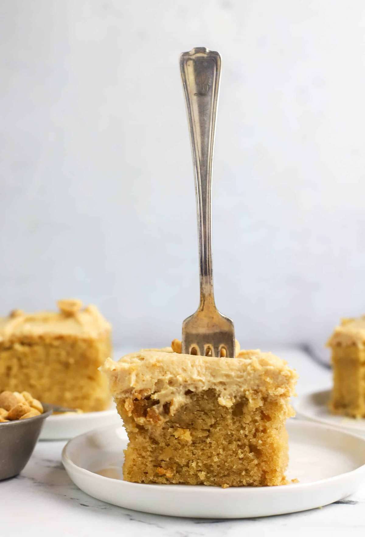 fork stuck in a slice of peanut butter cake