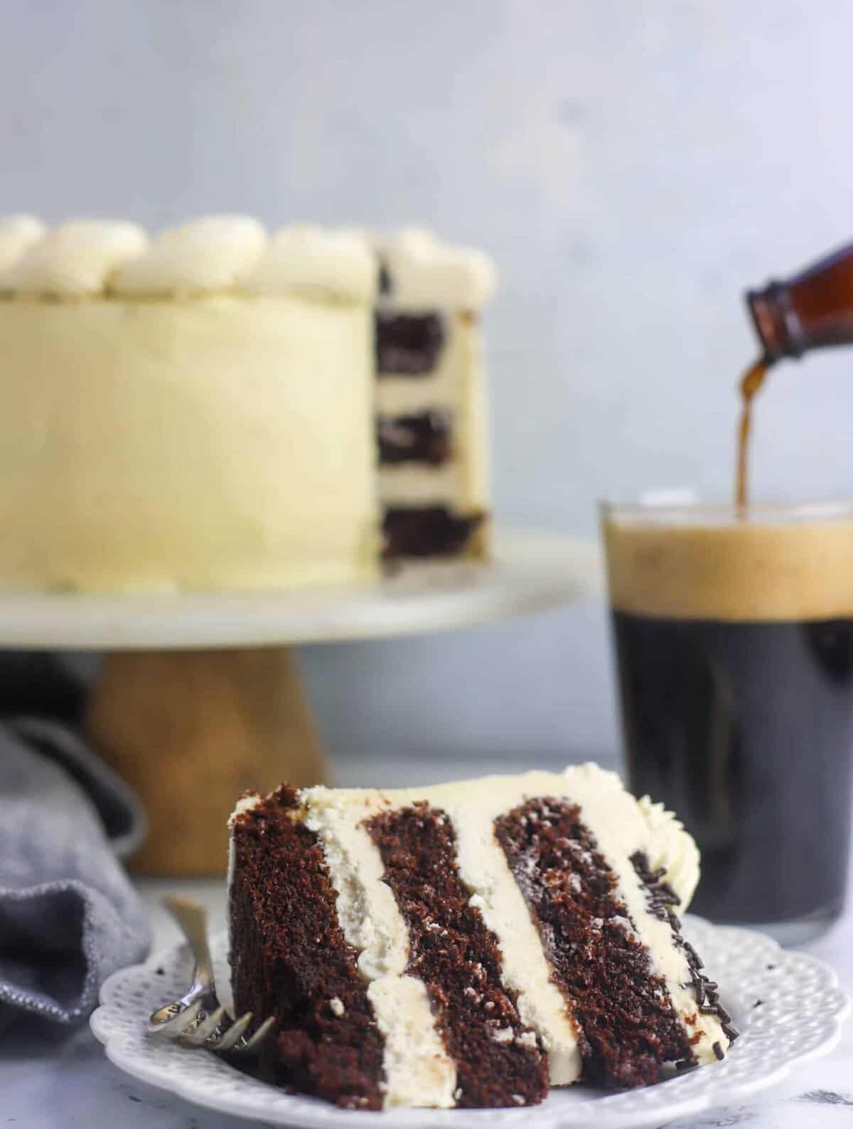 slice of Guinness cake with a Guinness being poured in background