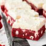 red velvet bars with cream cheese frosting on a cookie sheet