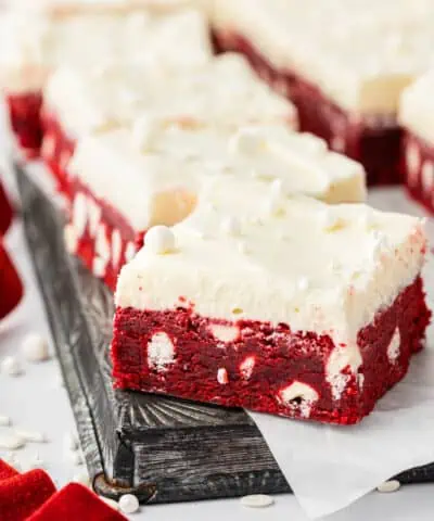 red velvet bars with cream cheese frosting on a cookie sheet