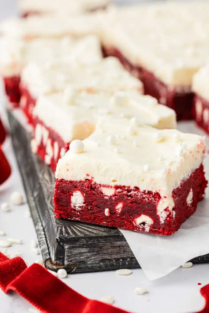 red velvet bars with cream cheese frosting on a cookie sheet