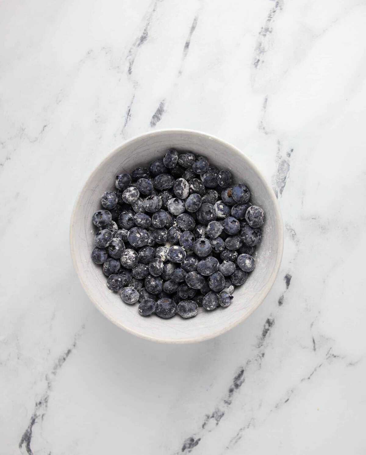 blueberries tossed in flour in a bowl