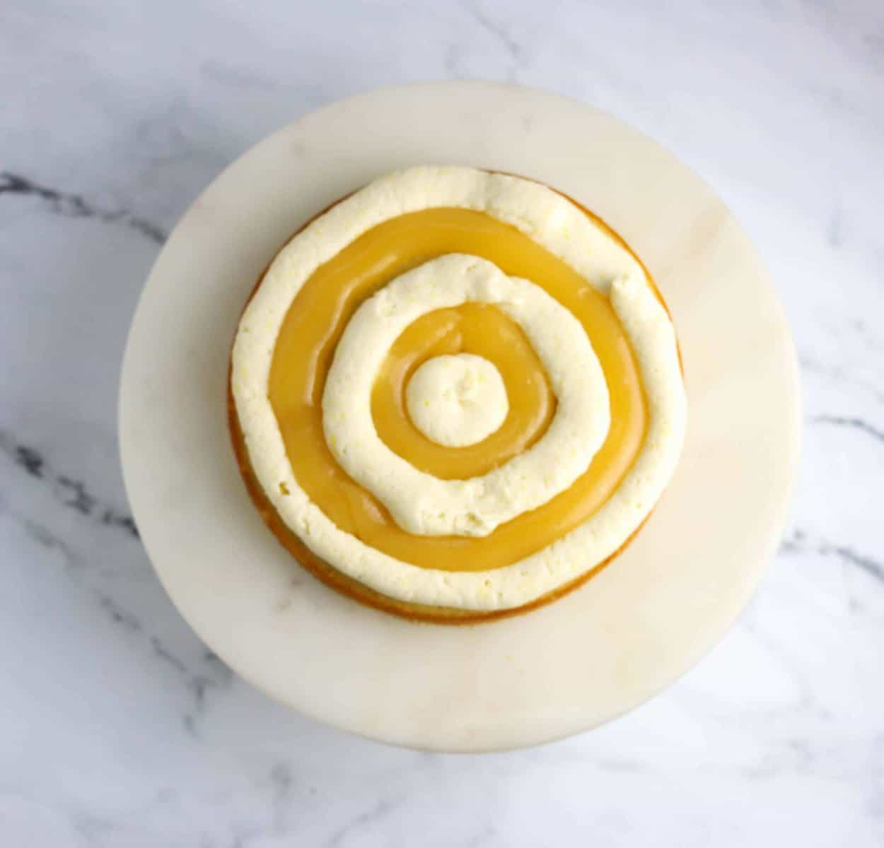 lemon cake layer filled with frosting and lemon curd