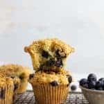 two sourdough blueberry muffins stacked on top of each other