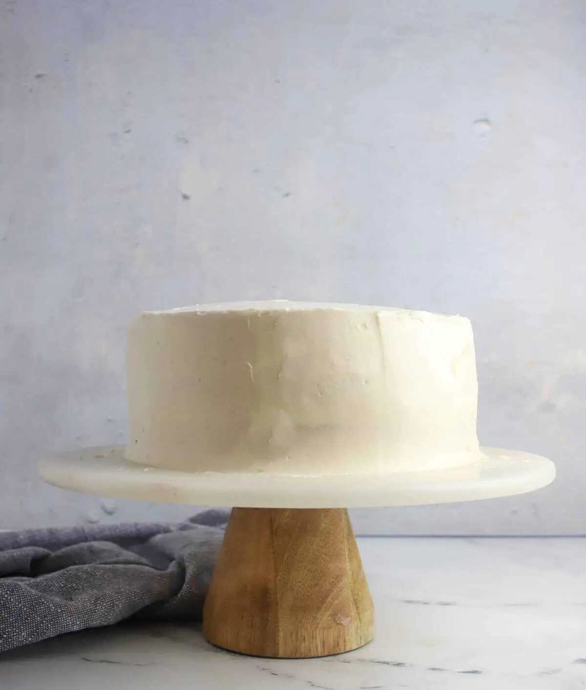 frosted layer cake on a cake stand