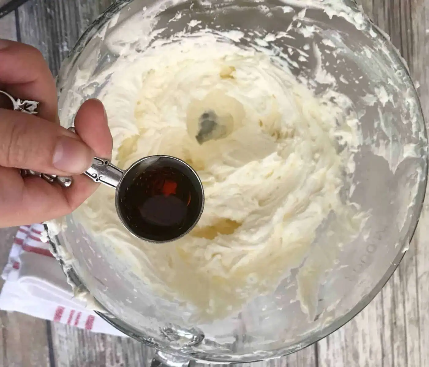 vanilla being added to buttercream frosting