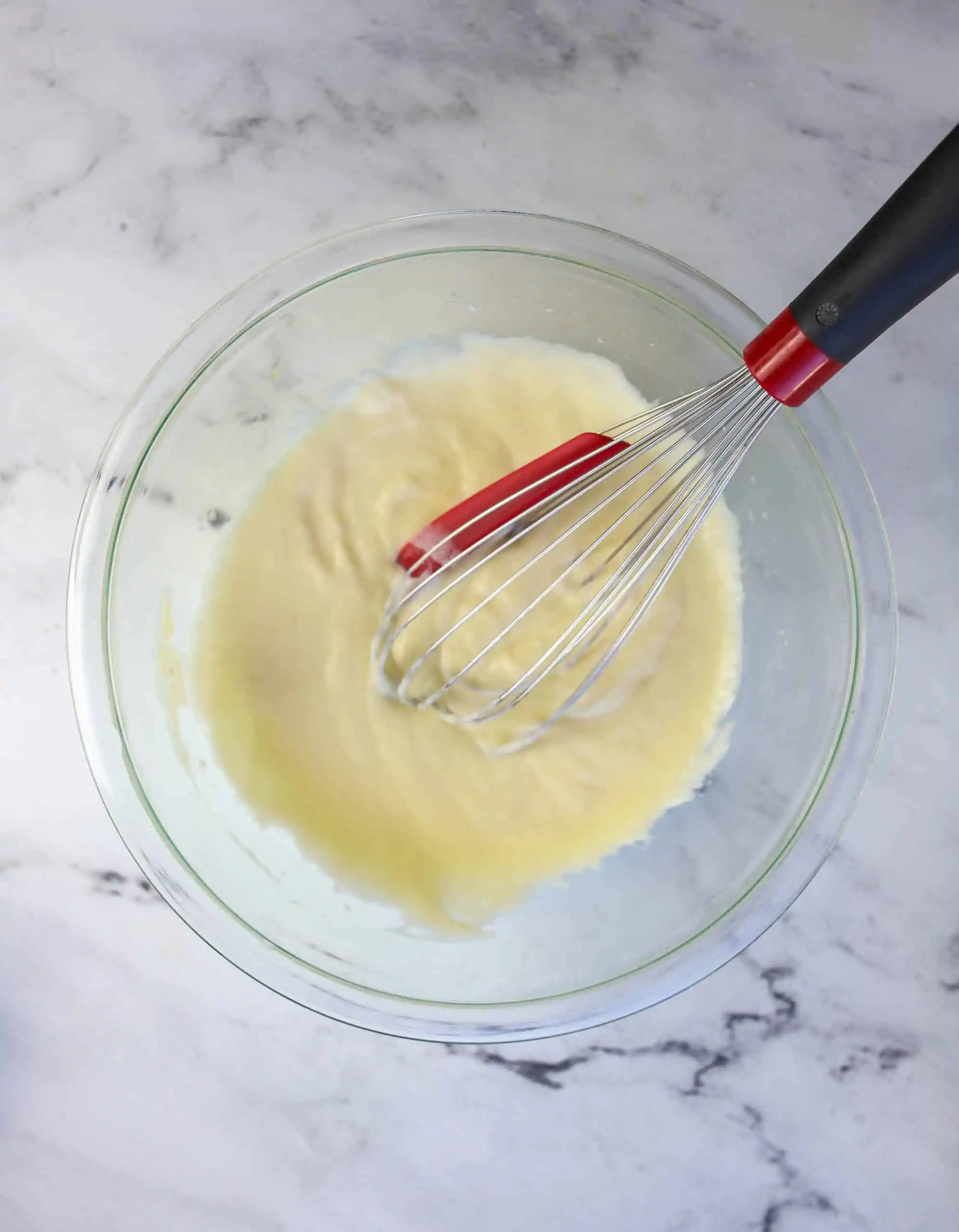 muffin wet ingredients in a bowl with a whisk