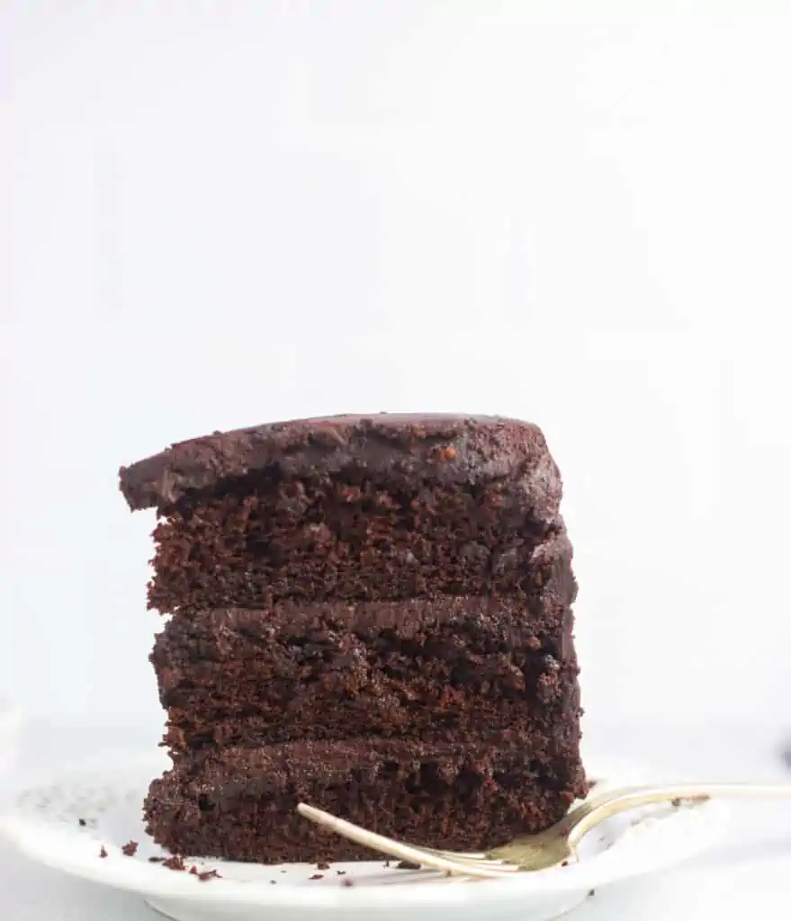 slice of sourdough chocolate cake on a plate standing upright