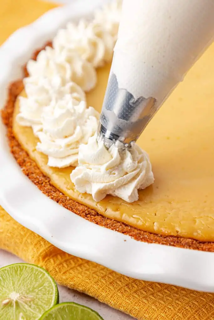 whipped cream piped onto a key lime pie