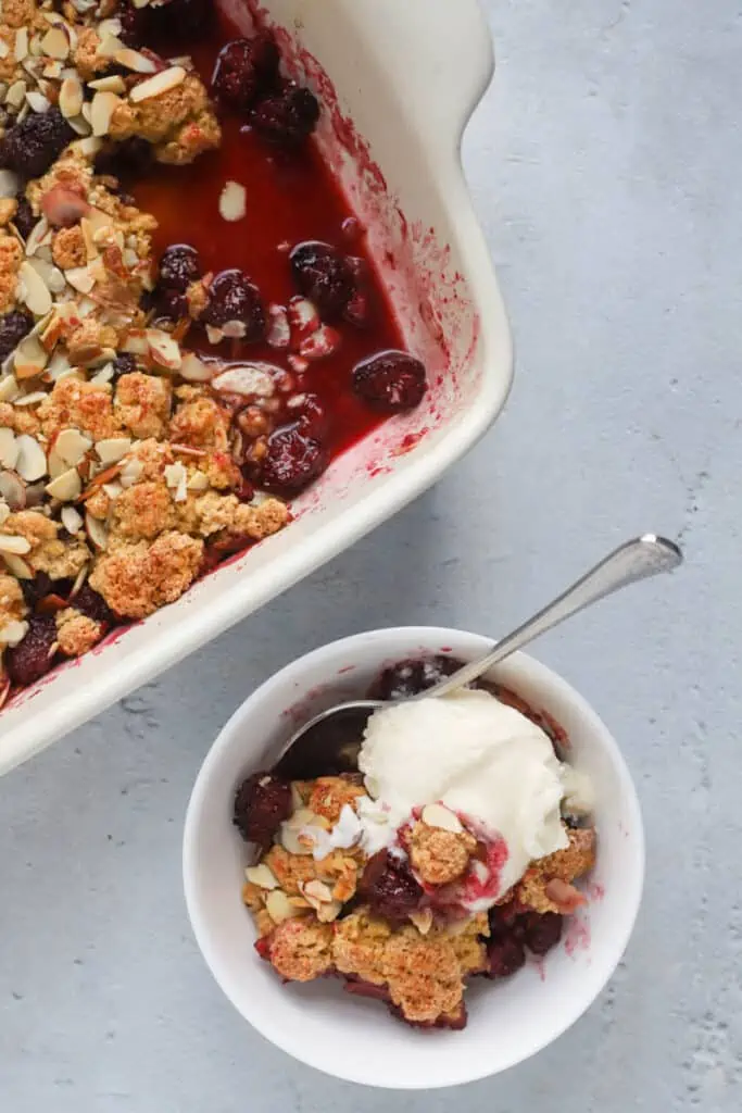bowl of blackberry crumble topped with icecream