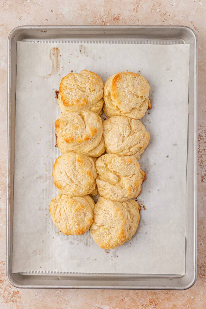eight baked biscuits on a cookie sheet