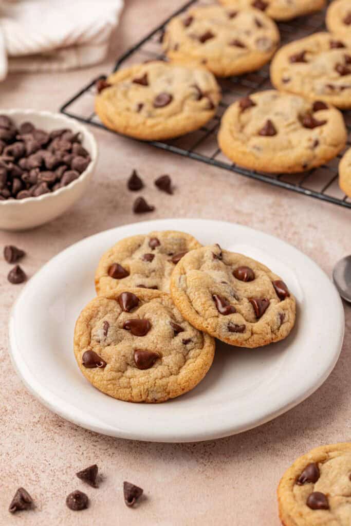 a plate of three eggless chocolate chip cookies