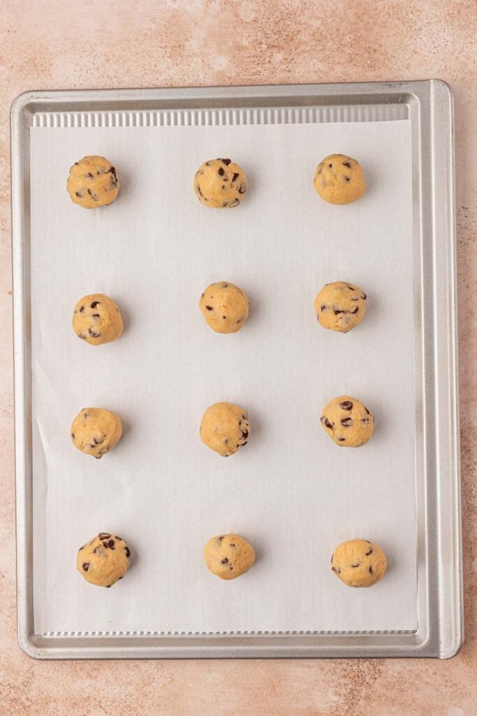 cookie dough balls on a cookie sheet