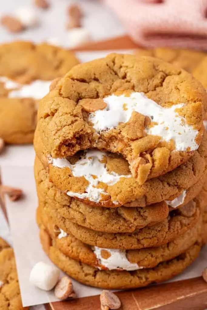 stack of fluffernutter cookies with the top cookie has a bite taken out of it