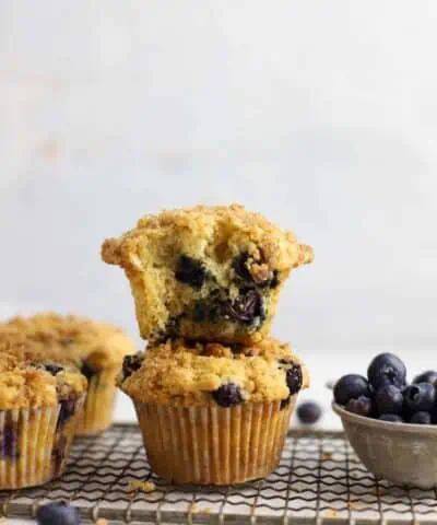 two sourdough blueberry muffins stacked on top of each other