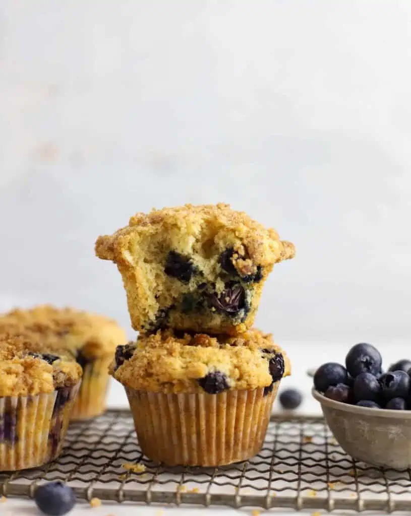 two sourdough blueberry muffins stacked on top of each other
