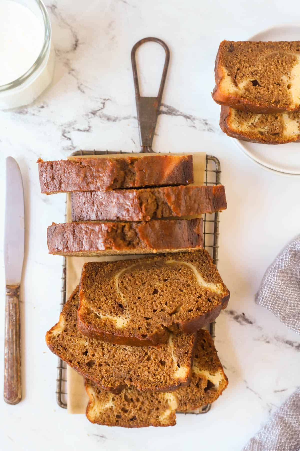 cream cheese filled pumpkin bread sliced on a wire rack