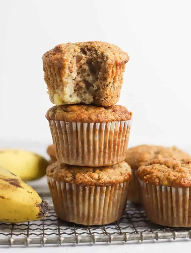 three sourdough banana muffins stacked on top of each other