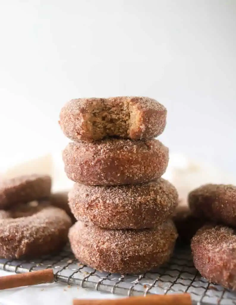 four apple cider donuts stacked