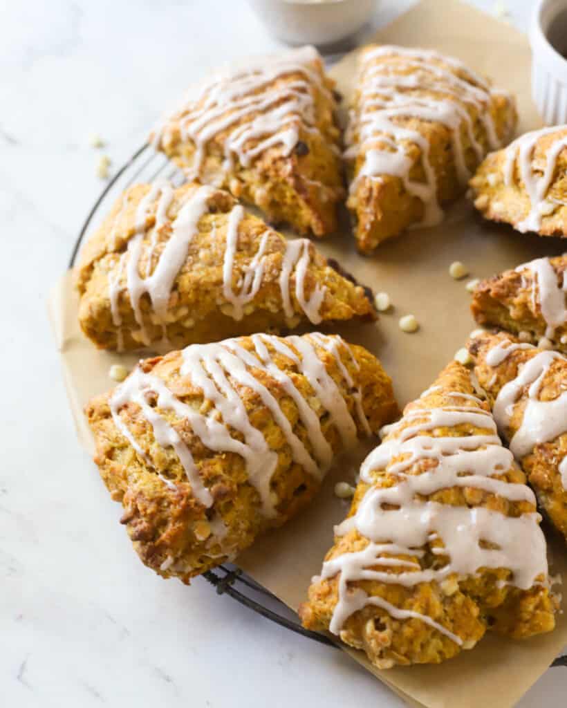 pumpkin scones on a wire rack with parchment paper