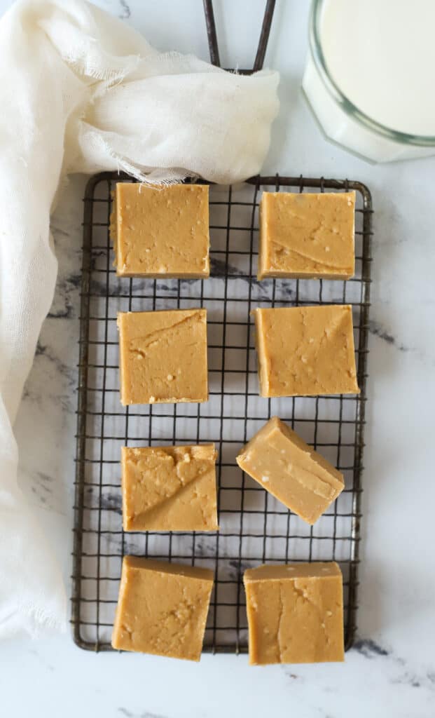 squares of old fashioned peanut butter fudge on a wire rack