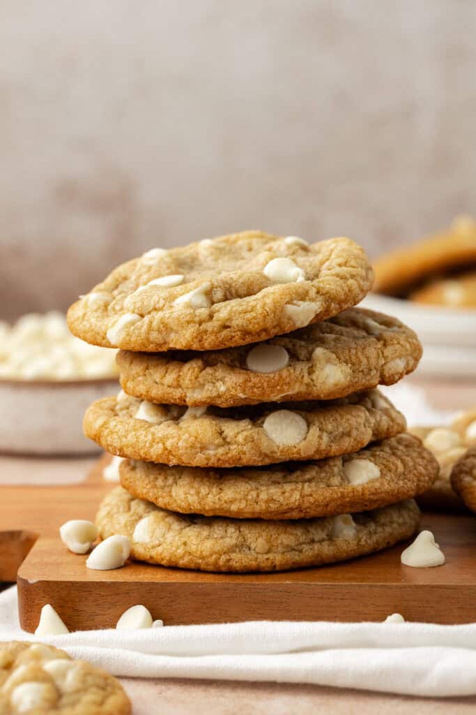 four white chocolate chip cookies stacked on top of each other