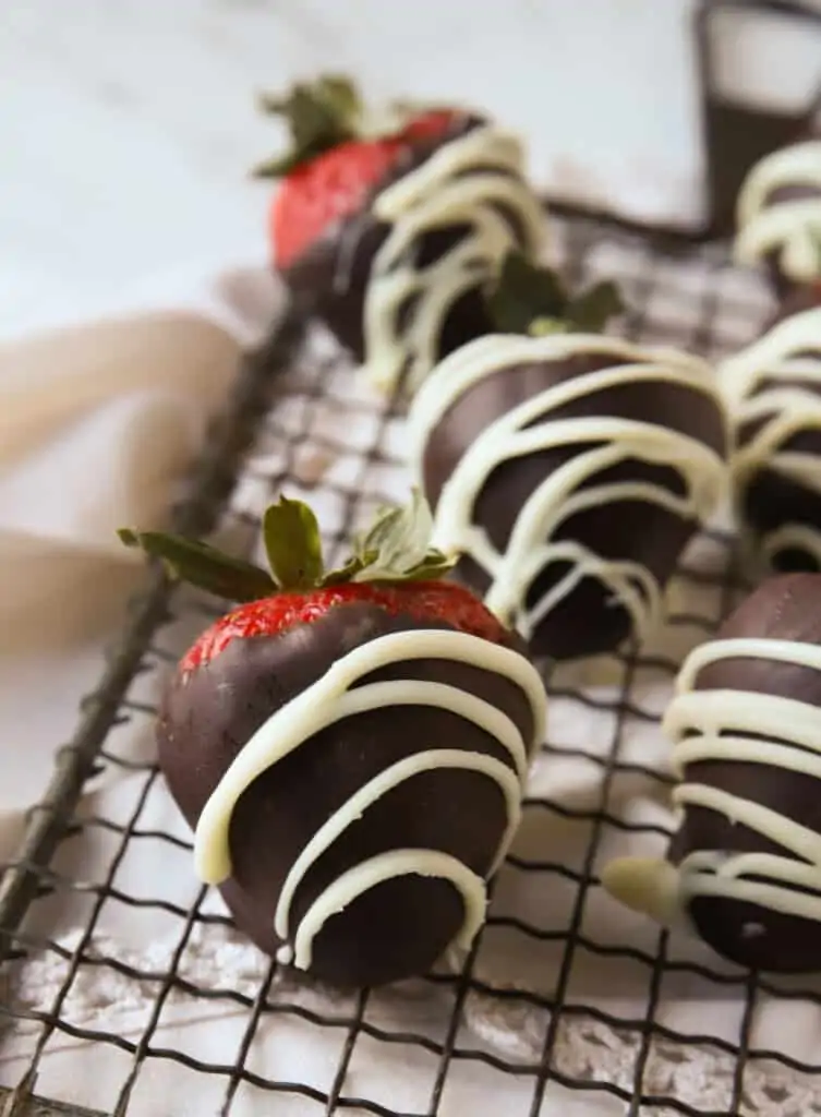 chocolate covered strawberries on a wire cooling rack