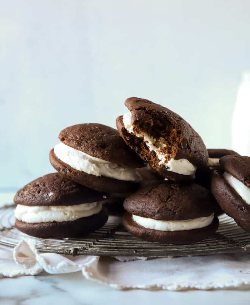 several chocolate whoopie pies stacked on top of each other on a wire cooling rack