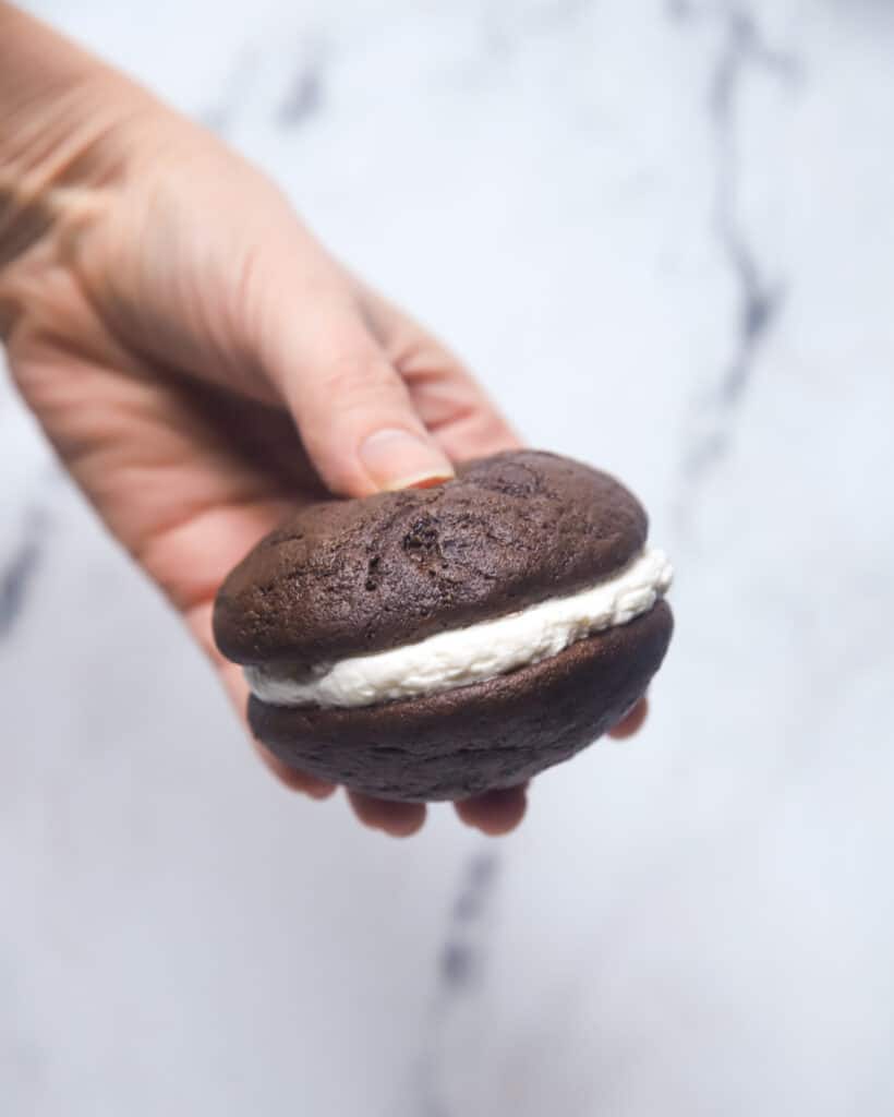 hand pressing a chocolate whoopie pie together