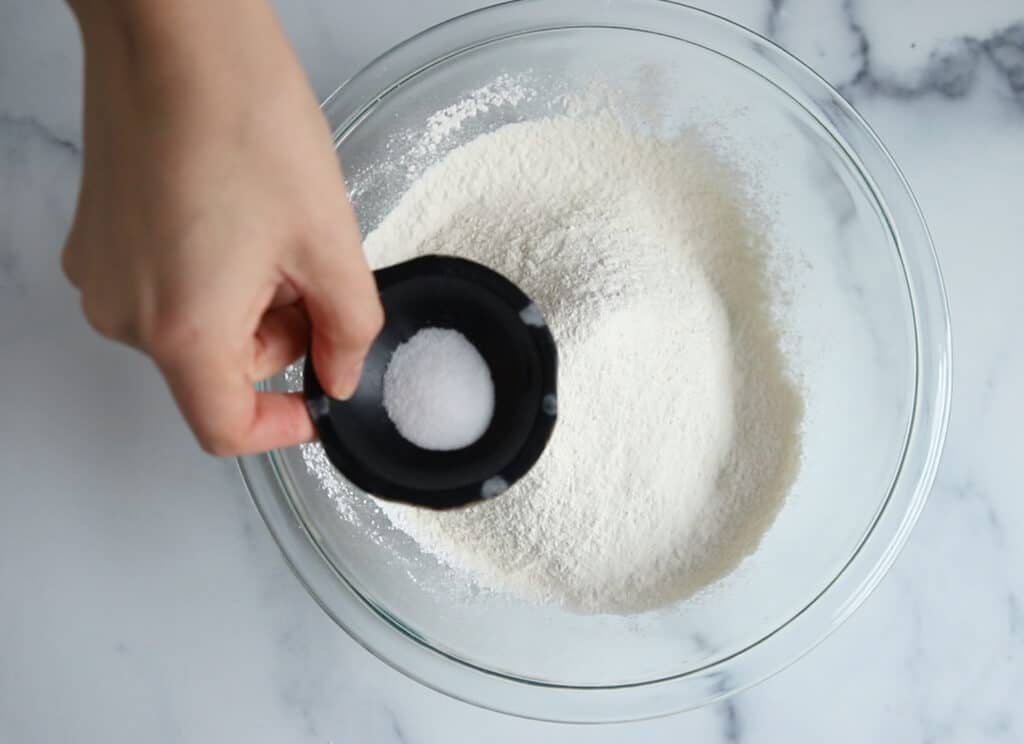salt being stirred into white cake recipe dry ingredients 