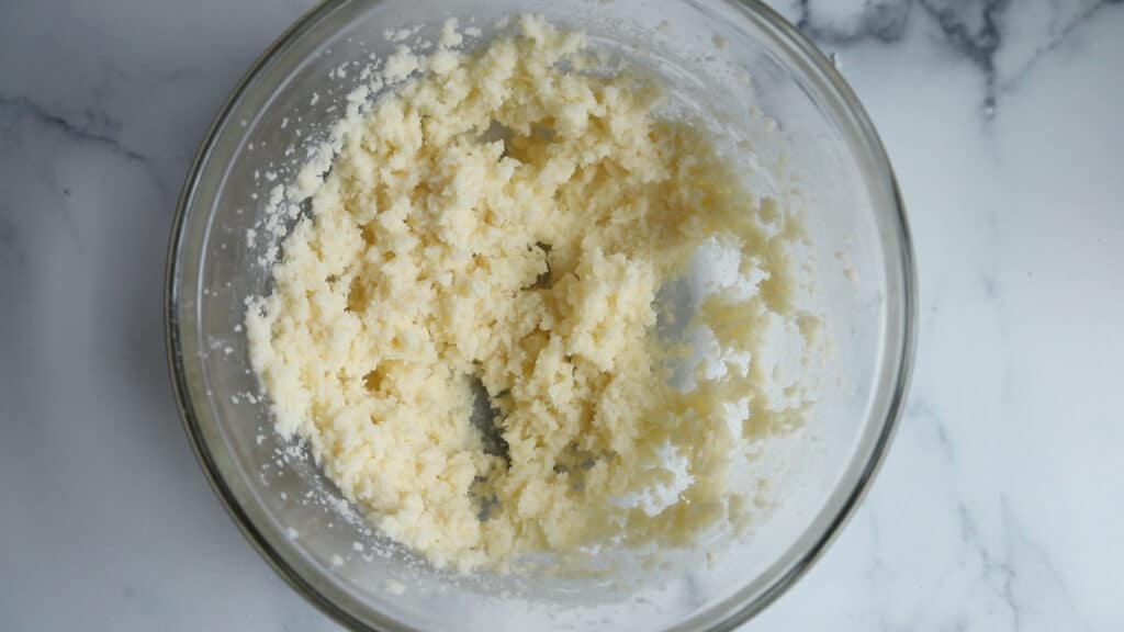 butter and sugar that's creamed together in a glass mixing bowl