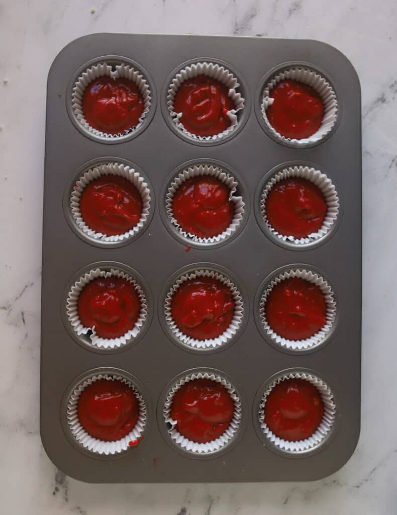 cupcake tin with unbaked red velvet cupcakes