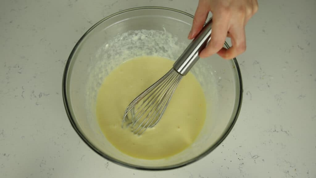 chocolate cupcake wet ingredients in a bowl with a whisk