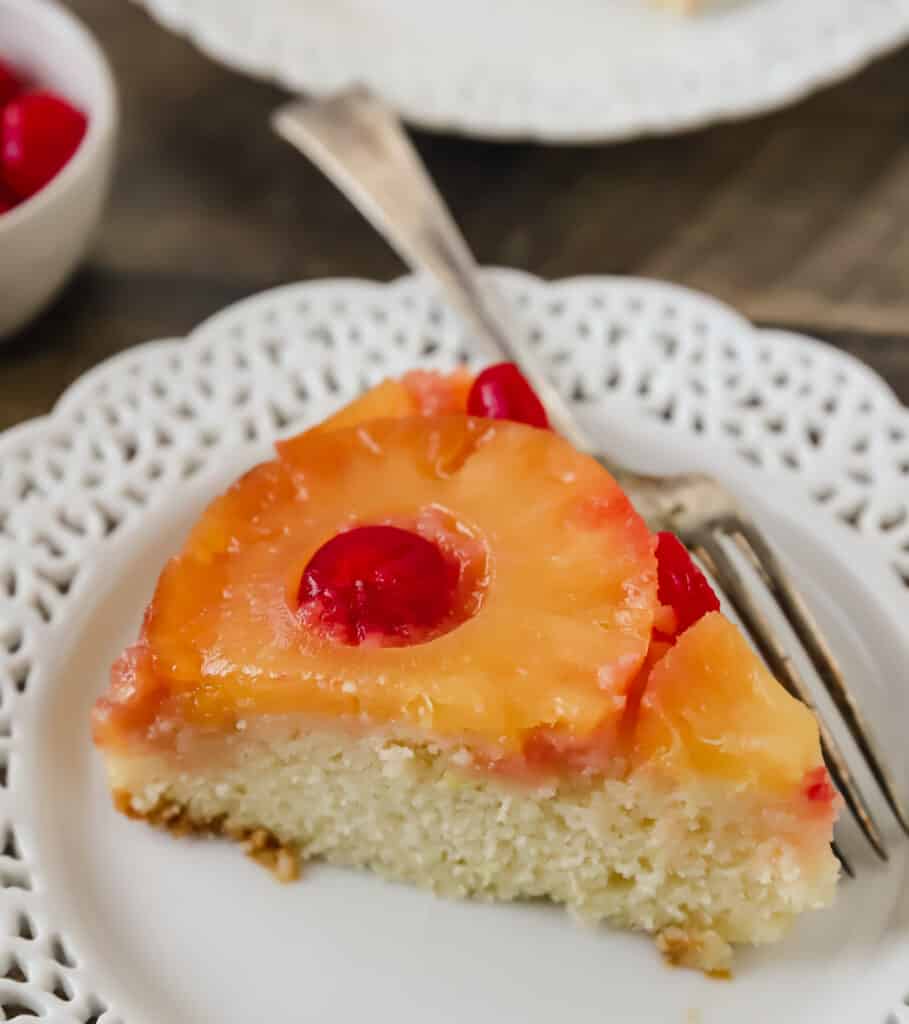 slice of pineapple upside down cake on a plate with a fork