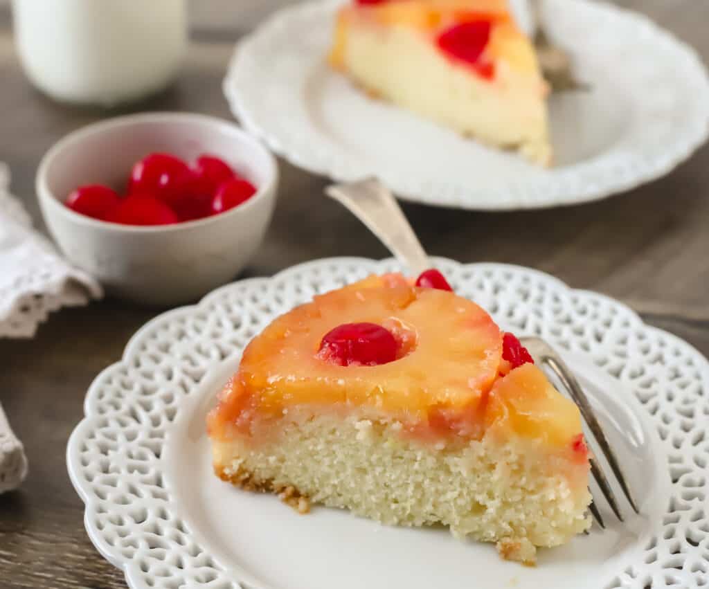 slice of pineapple upside down cake on a plate with a fork